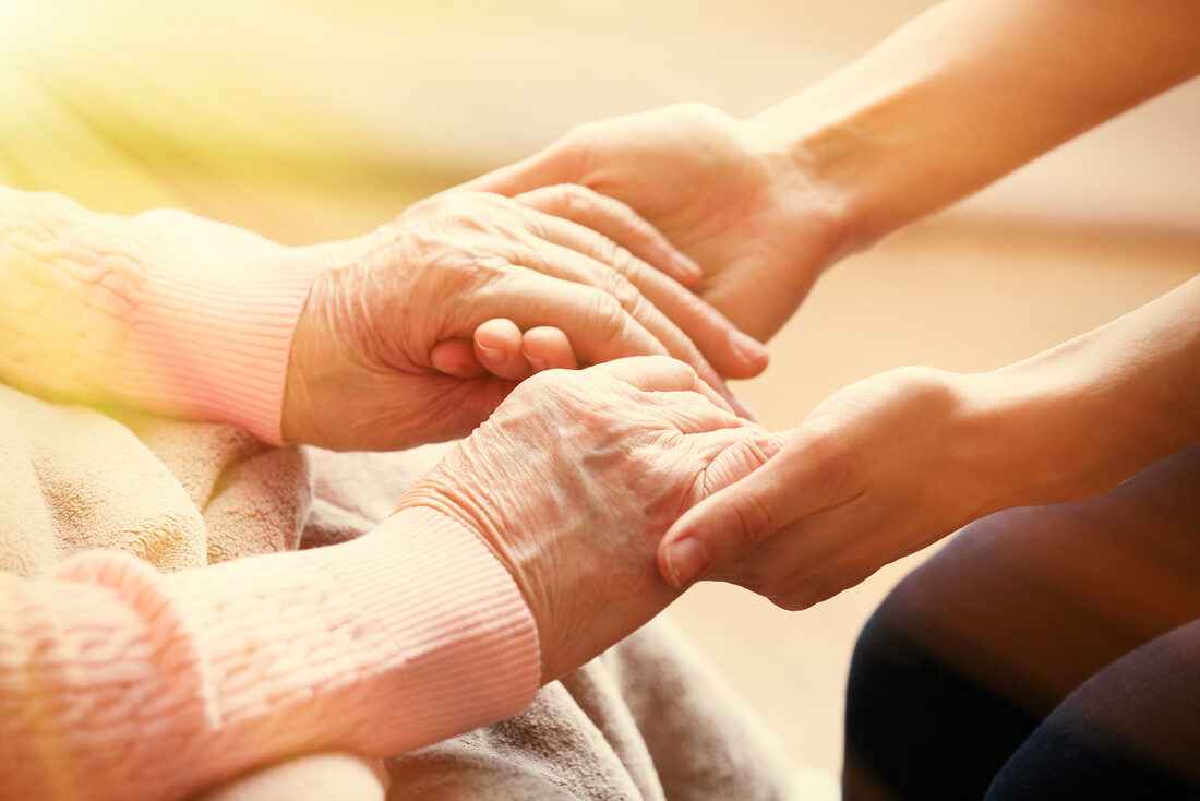 Caregiver holding the hands of a senior
